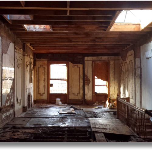 Historic townhouse interior opened to original joists and wall finishes before restoration