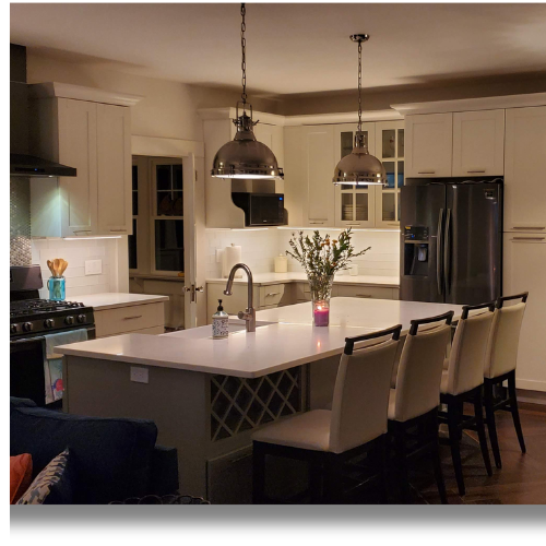 Completed kitchen with island seating and pendant lighting