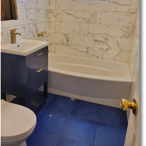 Completed bathroom with marble-look wall tile and a modern vanity
