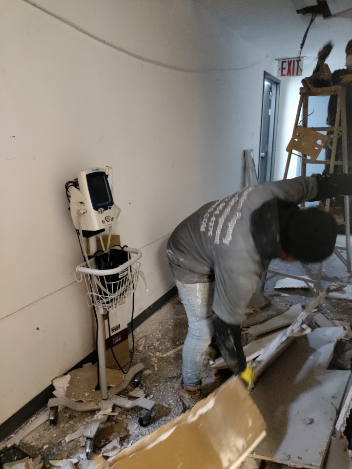 Crew removing damaged material during an interior demolition project